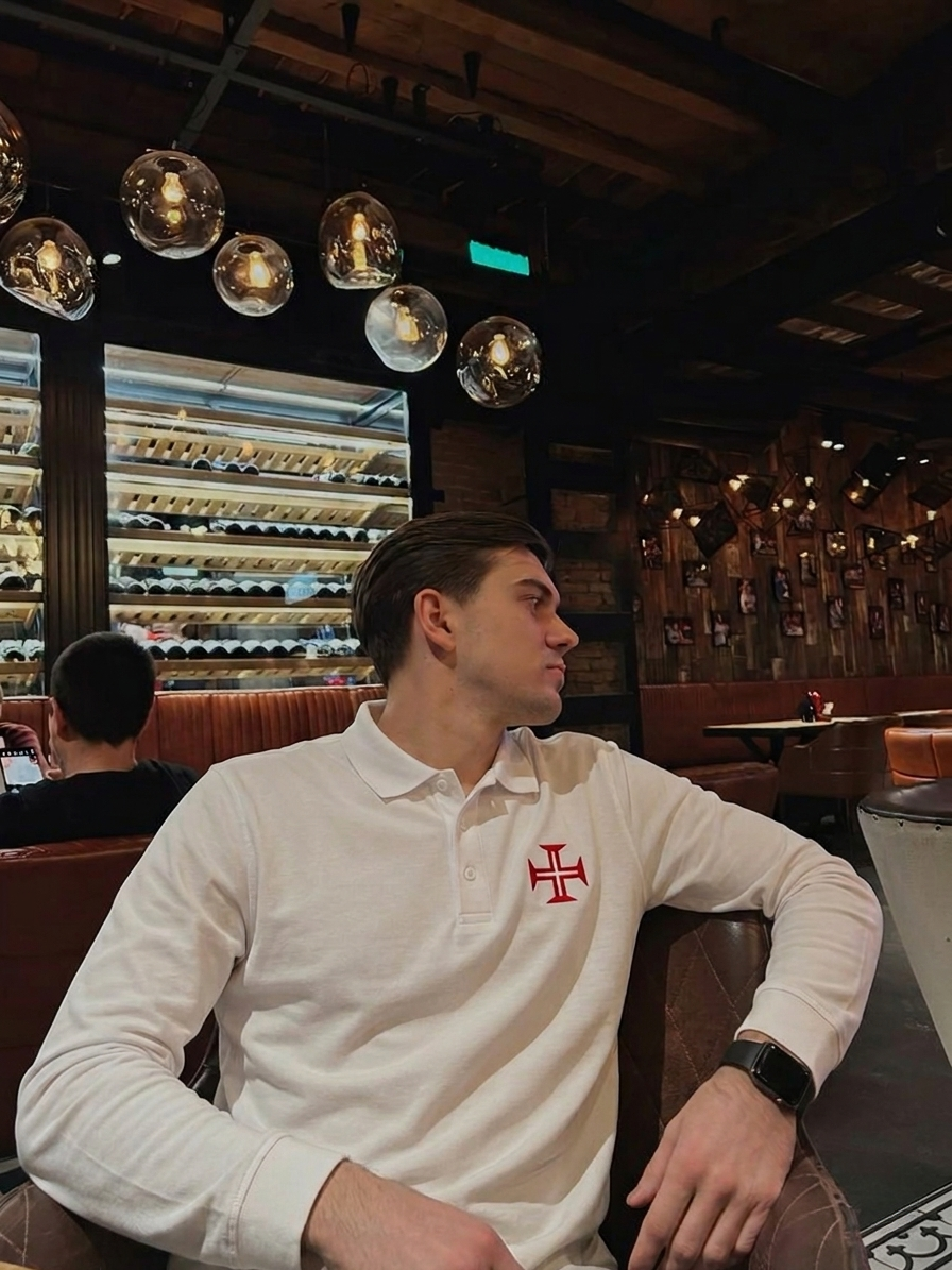 Man sitting in a bar or restaurant with wine bottles in the background