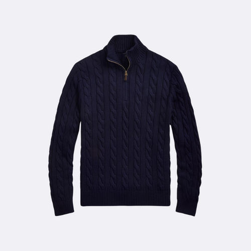 Navy blue cable knit sweater on a light gray background