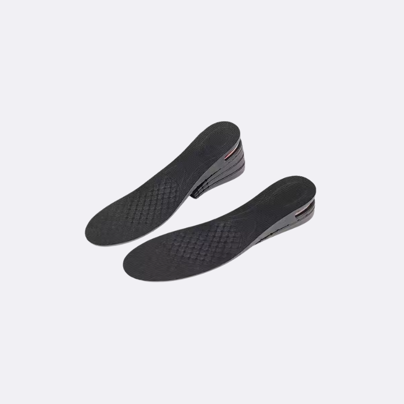 Pair of black shoe insoles on a light gray background